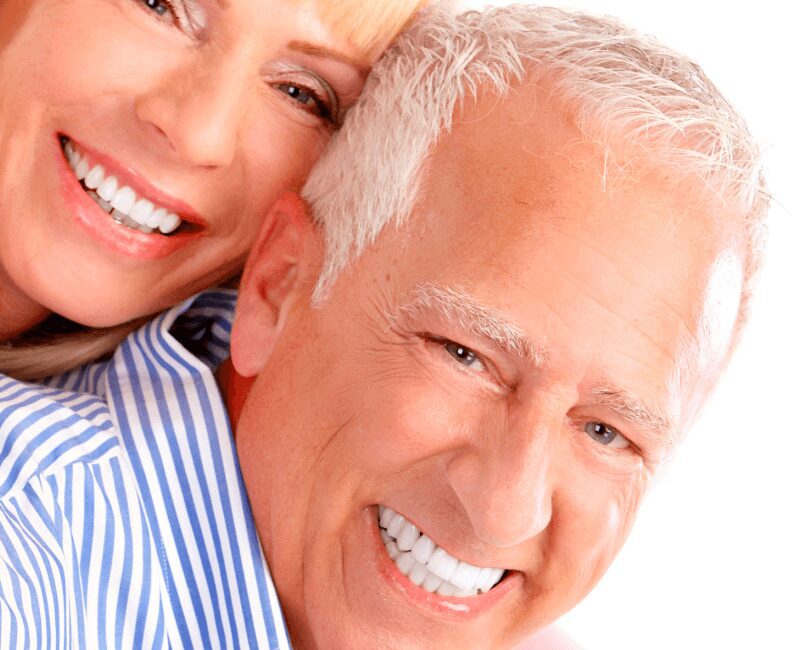 Beaming silver-haired pair close-up portrait