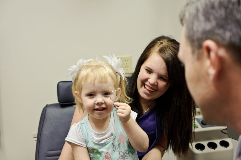 Little girl and mother visiting an ophthalmologist