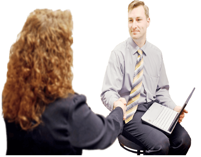 Seated man with laptop shaking woman's hand