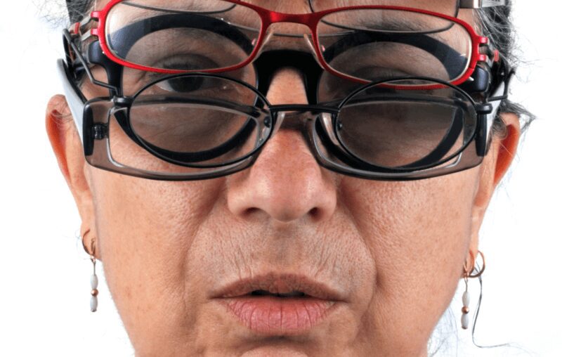 Red and black frames stacked on face